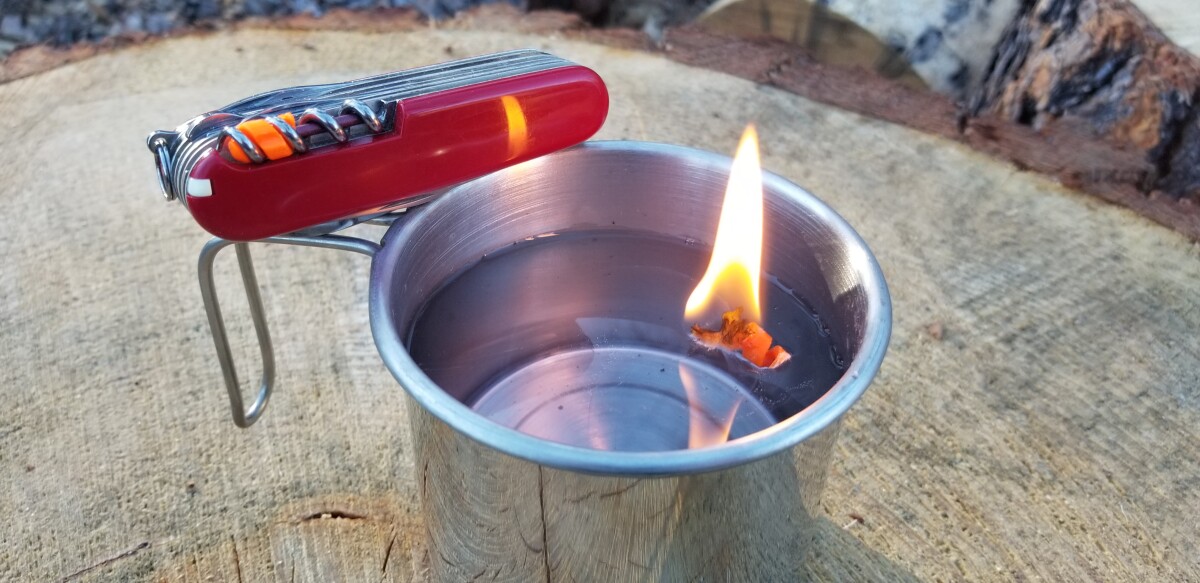 Shown here burning while floating, the FireAnt tinder features a waterproof waxed cotton composition
